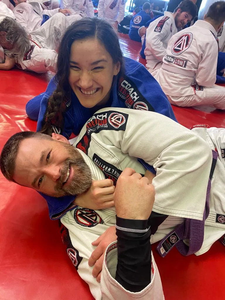 Two students rolling on the mats