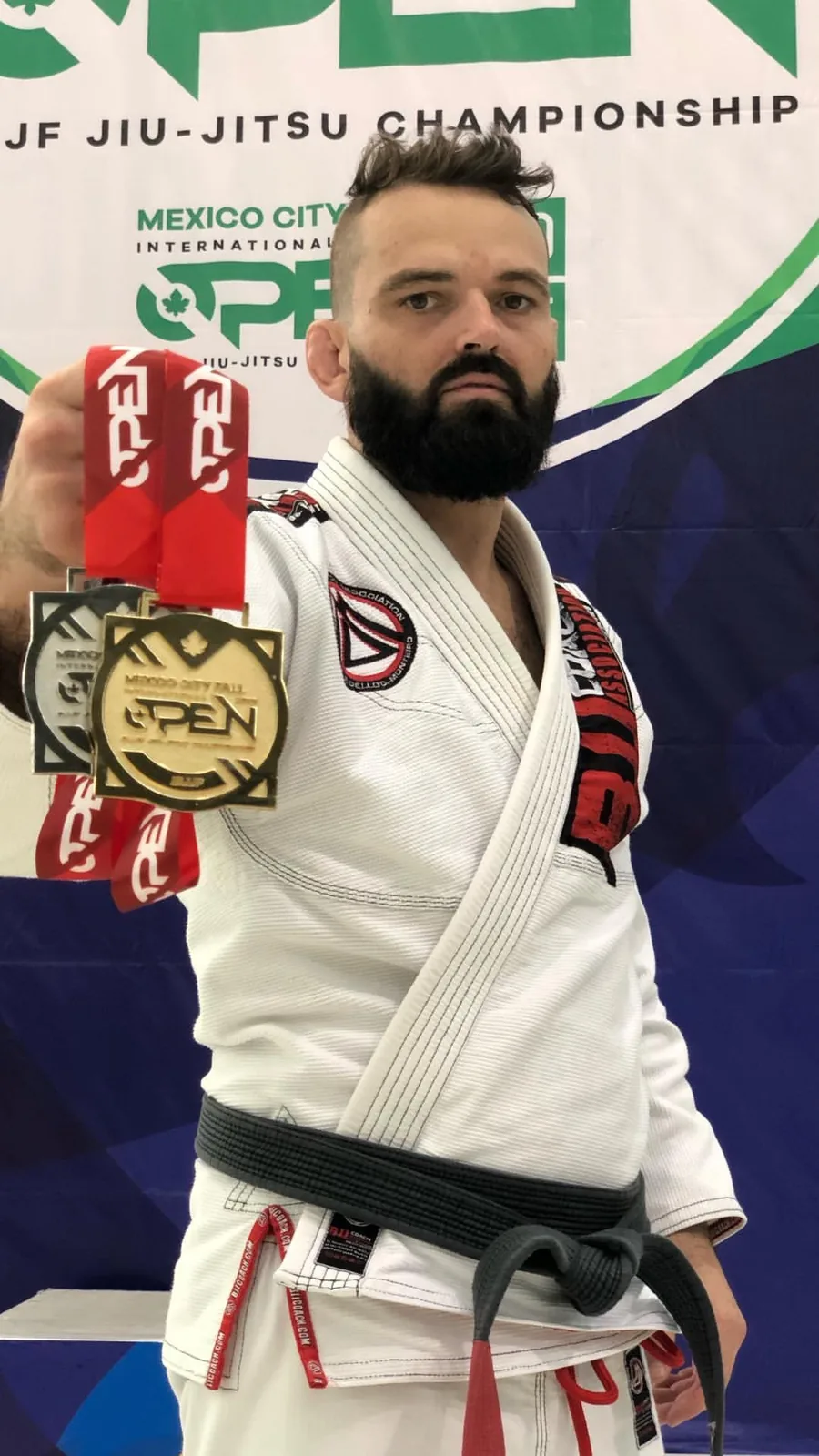 Coach Jon Correa with a championship medal