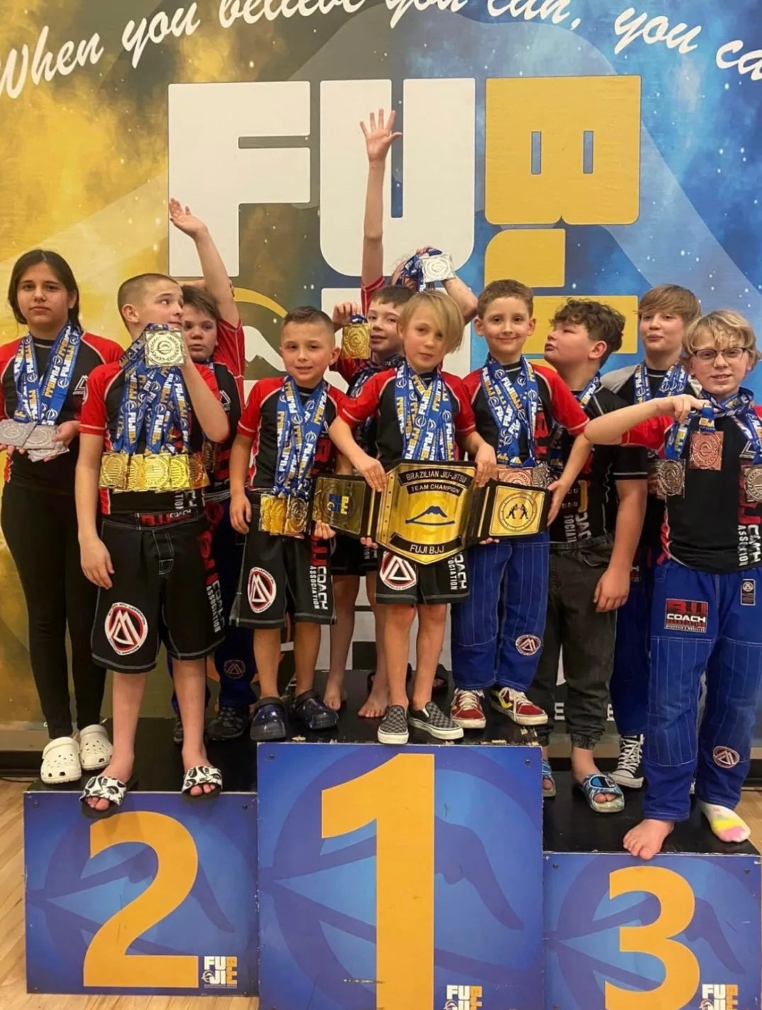 Kids competition team on the podium with their medals